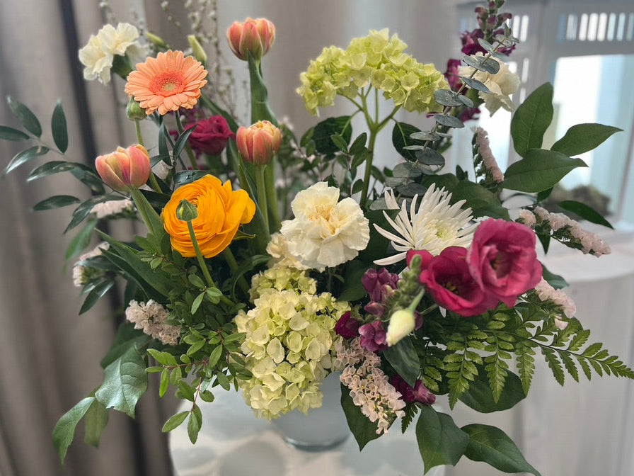 Green, Peach, and white flowers in white vase