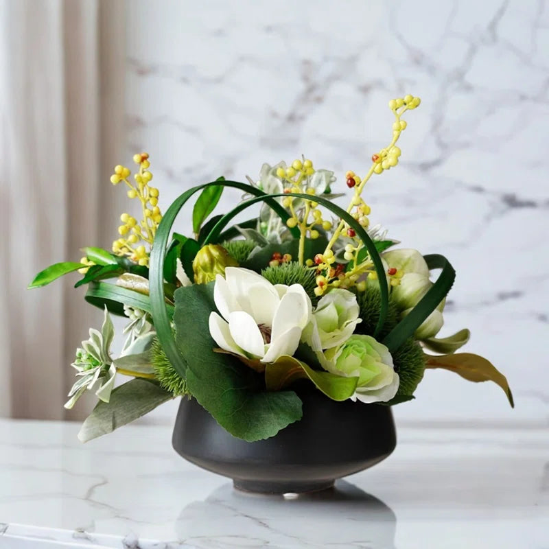 Black vase designed with modern white and green silk flowers for a modern style