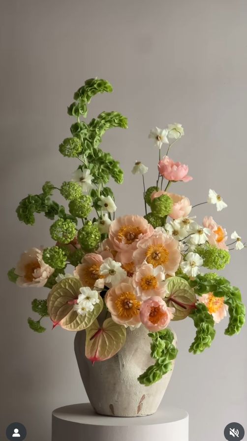 Floral arrangement in a vase on a gray background